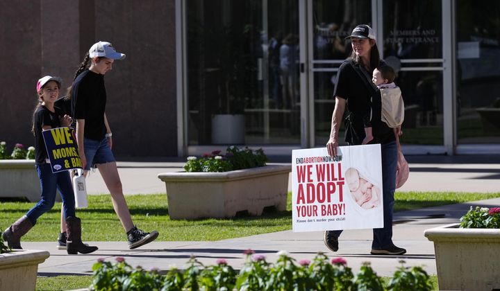 Pro-life demonstrators walk in the front of the Arizona Capitol prior to the vote on the proposed repeal of the state&#x27;s near-total ban on abortions prior to winning approval from the state House on, April 24, 2024, in Phoenix. Democrats at the Arizona Legislature are expected to make a final push Wednesday, May 1, to repeal the state’s long-dormant ban on nearly all abortions that a court said can be enforced. (AP Photo/Ross D. Franklin, File)
