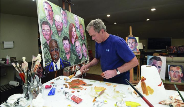 This photo provided by the George W. Bush Presidential Center shows former President George W. Bush working on a portrait of service members and veterans. The George W. Bush Institute is loaning the 60 color portraits by the former U.S. president to Walt Disney World. The paintings of service members and veterans will be on display for a year starting next month at Epcot&#x27;s American Adventure pavilion. (Courtesy of the George W. Bush Presidential Center via AP)