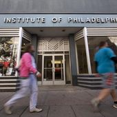 People walk past the Art Institute of Philadelphia operated by the Education Management Corp. on Nov. 16, 2015, in Philadelphia. The Biden administration on Wednesday said it will cancel $6 billion in student loans for people who attended the Art Institutes, a system of for-profit colleges that closed the last of its campuses in 2023 amid accusations of fraud. (AP Photo/Matt Rourke, File)