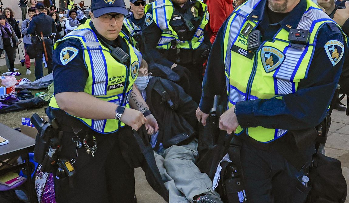 Madison Police carry a demonstrator protesting the war in Gaza as they work to remove a non-sanctioned encampment on the campus of UW-Madison in Madison, Wis., on Wednesday, May 1, 2024. (John Hart/Wisconsin State Journal via AP)
