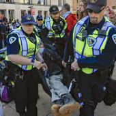 Madison Police carry a demonstrator protesting the war in Gaza as they work to remove a non-sanctioned encampment on the campus of UW-Madison in Madison, Wis., on Wednesday, May 1, 2024. (John Hart/Wisconsin State Journal via AP)