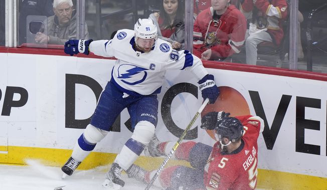 Tampa Bay Lightning center Steven Stamkos (91) and Florida Panthers defenseman Aaron Ekblad (5) battle for the puck during the first period of Game 5 of the first-round of an NHL Stanley Cup Playoff series, Monday, April 29, 2024, in Sunrise, Fla. (AP Photo/Wilfredo Lee) **FILE**