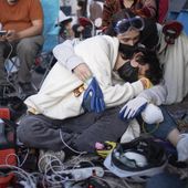 Pro-Palestinian demonstrators embrace while charging devices at an encampment on the UCLA campus Wednesday, May 1, 2024, in Los Angeles. (AP Photo/Ethan Swope)