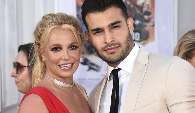 Britney Spears and Sam Asghari appear at the Los Angeles premiere of &quot;Once Upon a Time in Hollywood&quot; on July 22, 2019. Spears has reached a divorce settlement with her soon-to-be-ex-husband Asghari. (Photo by Jordan Strauss/Invision/AP, File)