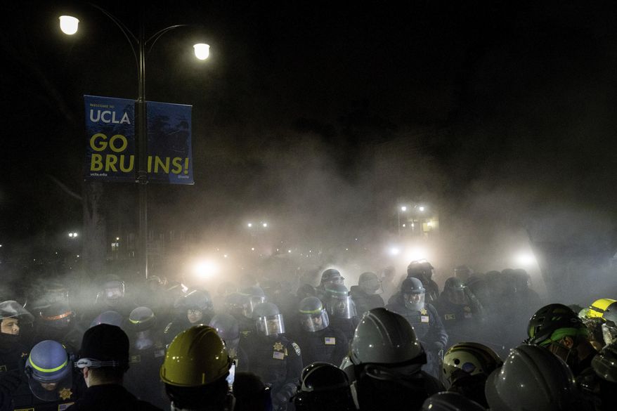Police advance on pro-Palestinian demonstrators on the UCLA campus Thursday, May 2, 2024, in Los Angeles. (AP Photo/Ethan Swope, File)