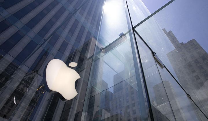 In this June 16, 2020 file photo, the sun is reflected on Apple&#x27;s Fifth Avenue store in New York. Apple will reported earnings on Thursday, May 2, 2024. (AP Photo/Mark Lennihan, File)