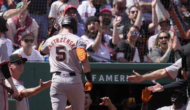 San Francisco Giants&#x27; Mike Yastrzemski (5) is congratulated after his solo home run during the third inning of a baseball game against the Boston Red Sox at Fenway Park, Thursday, May 2, 2024, in Boston. (AP Photo/Charles Krupa)