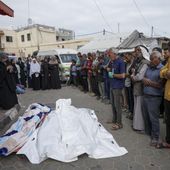 Mourners pray over the bodies of Palestinians who were killed in an Israeli airstrike in Gaza Stirp, at the Al Aqsa hospital in Deir al Balah, Gaza, Thursday, May 2, 2024. (AP Photo/Abdel Kareem Hana)
