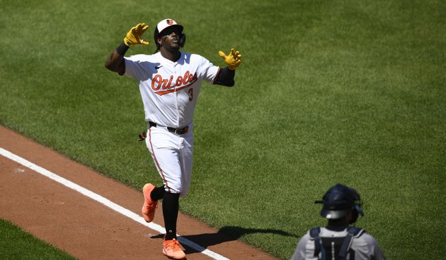 Baltimore Orioles&#x27; Jorge Mateo, left, celebrates his home run during the fourth inning of a baseball game as New York Yankees catcher Austin Wells looks on at lower right, Thursday, May 2, 2024, in Baltimore. (AP Photo/Nick Wass)