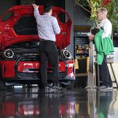 A salesperson shows an unsold 2024 Cooper SE electric hardtop to a prospective buyer at a Mini dealership Wednesday, May 1, 2024, in Highlands Ranch, Colo. On Friday, May 3, 2024, the U.S. government issues its April jobs report. (AP Photo/David Zalubowski)