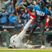 Philadelphia Phillies&#x27; Trea Turner, right, scores on the pass ball as San Francisco Giants starting pitcher Jordan Hicks, left, tries to make the tag during the fourth inning of a baseball game, Friday, May 3, 2024, in Philadelphia. (AP Photo/Chris Szagola)