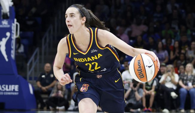 Indiana Fever guard Caitlin Clark looks to shoot against the Dallas Wings during the first half of an WNBA basketball game in Arlington, Texas, Friday, May 3, 2024. (AP Photo/Michael Ainsworth)