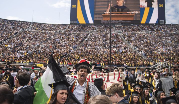 Rawan Antar, 21, center, chants in support of Palestinians during the University of Michigan&#x27;s Spring 2024 Commencement Ceremony at Michigan Stadium in Ann Arbor, Mich., on Saturday, May 4, 2024. (Katy Kildee/Detroit News via AP)