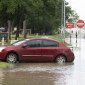 A stranded care is seen near the bridge over Lake Houston along West Lake Houston Parkway after it was closed due to high water on either side of the thoroughfare, Saturday, May 4, 2024, in Kingwood, Texas. (Jason Fochtman/Houston Chronicle via AP)