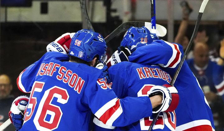 New York Rangers defenseman Erik Gustafsson (56), left wing Jimmy Vesey and others celebrate center Vincent Trocheck&#x27;s goal against the Carolina Hurricanes during the first period in Game 1 of an NHL hockey Stanley Cup second-round playoff series, Sunday, May 5, 2024, in New York. (AP Photo/Julia Nikhinson)