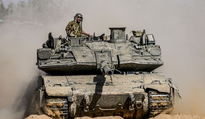 Israeli soldiers drive a tank at a staging ground near the border with the Gaza Strip, in southern Israel, Sunday, May 5, 2024. (AP Photo/Tsafrir Abayov)