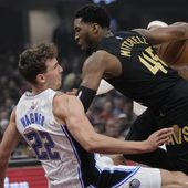 Orlando Magic forward Franz Wagner (22) fouls Cleveland Cavaliers guard Donovan Mitchell (45) and falls to the floor in the first half of Game 7 of an NBA basketball first-round playoff series Sunday, May 5, 2024, in Cleveland. (AP Photo/Sue Ogrocki)