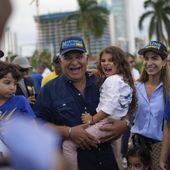 FILE - Presidential candidate Jose Raul Mulino holds his granddaughter Sofia accompanied by his daughter Monique, Sofia&#x27;s mother, during a campaign event, in Panama City, April 26, 2024. Mulino replaced former president Ricardo Martinelli as the candidate for the Achieving Goals party. Martinelli was barred from running in March, because the ex-president was sentenced to more than 10 years in prison for money laundering. (AP Photo/Matias Delacroix, File)