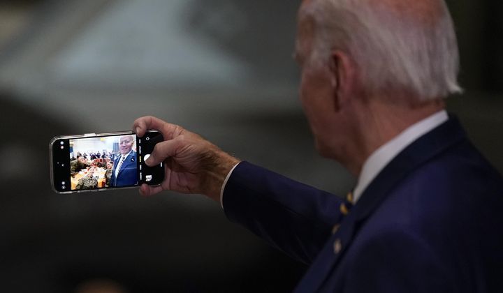 President Joe Biden takes a selfie at Marine Corps Air Station Cherry Point in Havelock, N.C., Monday, Nov. 21, 2022, at a Thanksgiving dinner with members of the military and their families. (AP Photo/Patrick Semansky, File)