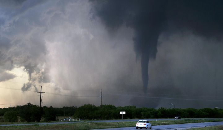 A tornado spins west of Hawley, Texas, as cars pass on U.S. 277 on Thursday May 2, 2024. (Ronald W. Erdrich/The Abilene Reporter-News via AP)