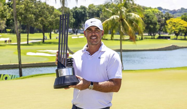 Individual champion captain Brooks Koepka, of Smash GC, poses with the trophy after the final round of LIV Golf Singapore at Sentosa Golf Club, Sunday, May 5, 2024, in Sentosa, Singapore. (Jon Ferrey/LIV Golf via AP)