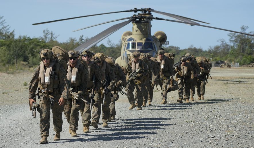 U.S. troopers prepare to board U.S. Army CH-47s at Paredes Air Station at Pasuquin, Ilocos Norte province as it carries U.S. and Philippine troops during a joint military exercise in northern Philippines on Monday, May 6, 2024. American and Filipino marines held annual combat-readiness exercises called Balikatan, Tagalog for shoulder-to-shoulder, in a show of allied military readiness in the Philippines' northernmost town facing southern Taiwan. (AP Photo/Aaron Favila)