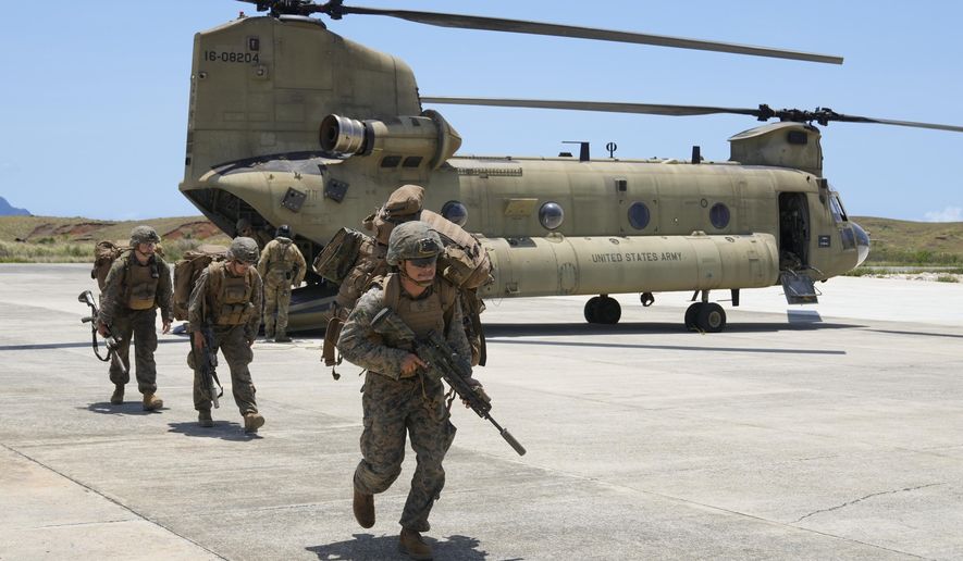 U.S. troopers alight from a U.S. Army CH-47 carrying American and Philippine troops as it lands at the Philippines' northernmost town of Itbayat, Batanes province during a joint military exercise on Monday, May 6, 2024. American and Filipino marines held annual combat-readiness exercises called Balikatan, Tagalog for shoulder-to-shoulder, in a show of allied battle readiness in the Philippines' northernmost island town of Itbayat along the strategic Bashi Channel off southern Taiwan. (AP Photo/Aaron Favila) **FILE**