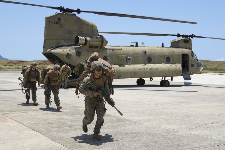 U.S. troopers alight from a U.S. Army CH-47 carrying American and Philippine troops as it lands at the Philippines' northernmost town of Itbayat, Batanes province during a joint military exercise on Monday, May 6, 2024. American and Filipino marines held annual combat-readiness exercises called Balikatan, Tagalog for shoulder-to-shoulder, in a show of allied battle readiness in the Philippines' northernmost island town of Itbayat along the strategic Bashi Channel off southern Taiwan. (AP Photo/Aaron Favila) **FILE**
