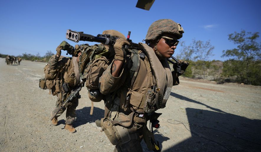 U.S. troopers prepare to board a U.S. Army CH-47s at Paredes Air Station at Pasuquin, Ilocos Norte province as it carries U.S. and Philippine troops during a joint military exercise in northern Philippines on Monday, May 6, 2024. American and Filipino marines held annual combat-readiness exercises called Balikatan, Tagalog for shoulder-to-shoulder, in a show of allied military readiness in the Philippines' northernmost town facing southern Taiwan. (AP Photo/Aaron Favila)