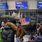 Pedestrians walk past the Nasdaq building as the stock price of Trump Media &amp; Technology Group Corp. is displayed on screens, March 26, 2024, in New York. On Friday, May 3, Trump Media and Technology Group, the owner of social networking site Truth Social, fired BF Borgers, an auditor that federal regulators recently charged with “massive fraud.” (AP Photo/Frank Franklin II, File)