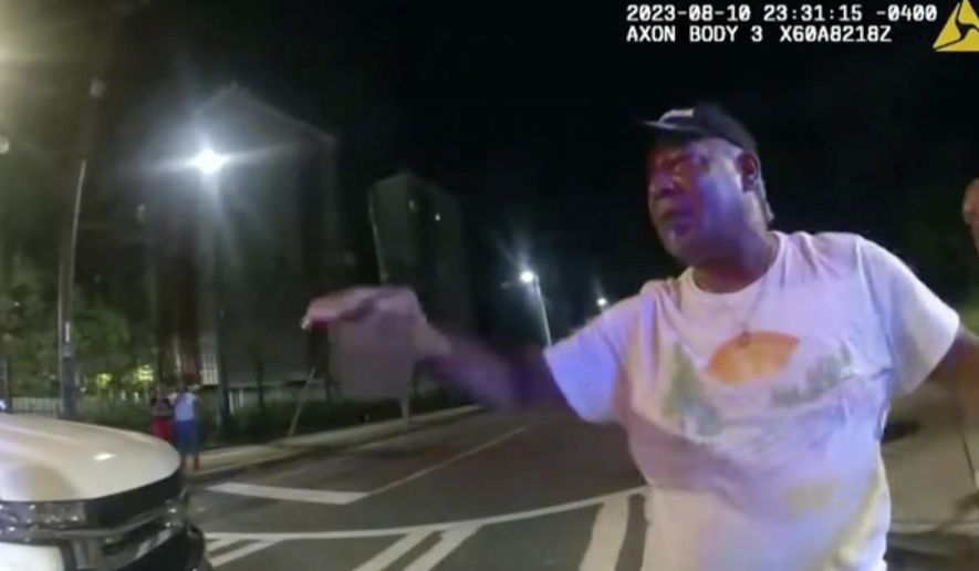 FILE - In this image taken from police bodycam video provided by the Atlanta Police Department, Johnny Hollman Sr. speaks with Officer Kiran Kimbrough on Aug. 10, 2023 in Atlanta. The Atlanta City Council has agreed to pay $3.8 million to settle a lawsuit by the family of Hollman, a church deacon who died in a struggle with a city police officer following a minor car crash. (Atlanta Police Department via AP, File)
