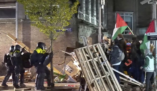 In this image taken from video, police arrest some 125 activists as they broke up a pro-Palestinian demonstration camp at the University of Amsterdam in Amsterdam, the Netherlands, Tuesday, May 7, 2024, as protests that have roiled campuses in the United States spread into Europe. (AP Photo InterVision)