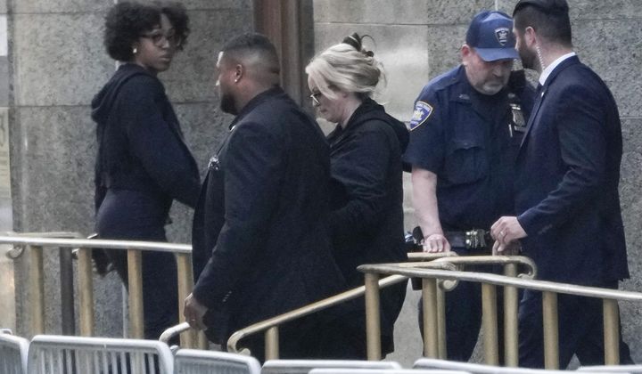 Stormy Daniels, center, exits the courthouse at Manhattan criminal court in New York, Tuesday, May 7, 2024. Porn actor Daniels, whose real name is Stephanie Clifford, took the stand mid-morning Tuesday and testified about her alleged sexual encounter with former President Donald Trump in 2006, among other things. (AP Photo/Seth Wenig)