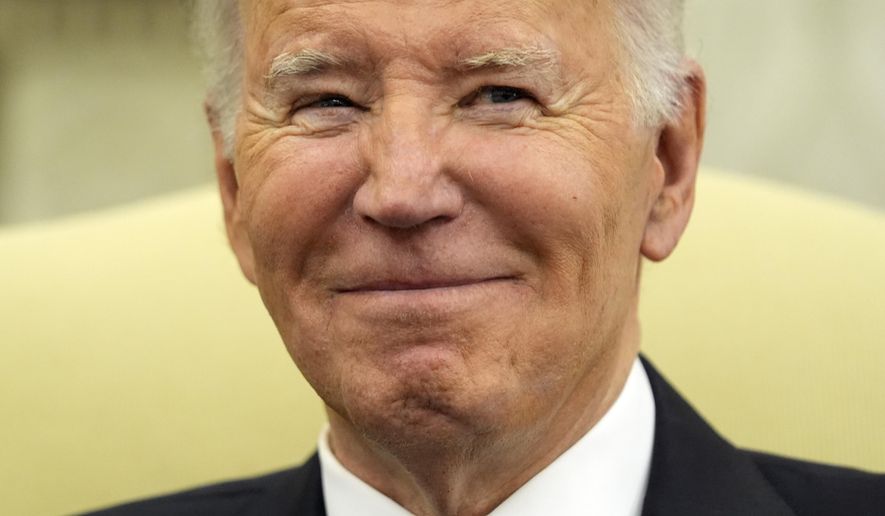 President Joe Biden smiles as he meets with Romania's President Klaus Iohannis in the Oval Office of the White House, Tuesday, May 7, 2024, in Washington. (AP Photo/Alex Brandon)