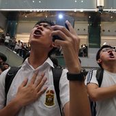 FILE - Local residents sing a theme song written by protesters &quot;Glory to Hong Kong&quot; at a shopping mall in Hong Kong on Sept. 11, 2019. An appeals court Wednesday, May 8, 2024 granted the Hong Kong government&#x27;s request to ban a popular protest song, overturning an earlier ruling and deepening concerns over the erosion of freedoms in the once-freewheeling global financial hub. (AP Photo/Vincent Yu, File)