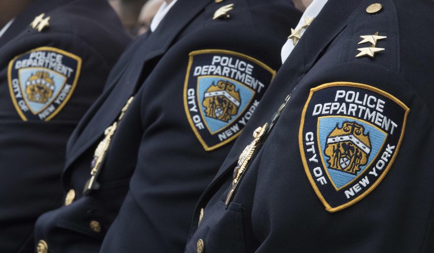 Members of the New York City Police Department listen to a news conference, Jan. 4, 2017, in New York. New York City's watchdog agency has launched an investigation into allegations that the city's police department improperly used its official social media accounts to target public officials and private citizens. The city Department of Investigation confirmed the probe in a statement Wednesday, May 8, 2024, saying it was prompted by recent requests from City Council Speaker Adrienne Adams and the Legal Aid Society asking it to look into the NYPD's social media policies and practices. (AP Photo/Mary Altaffer, File)
