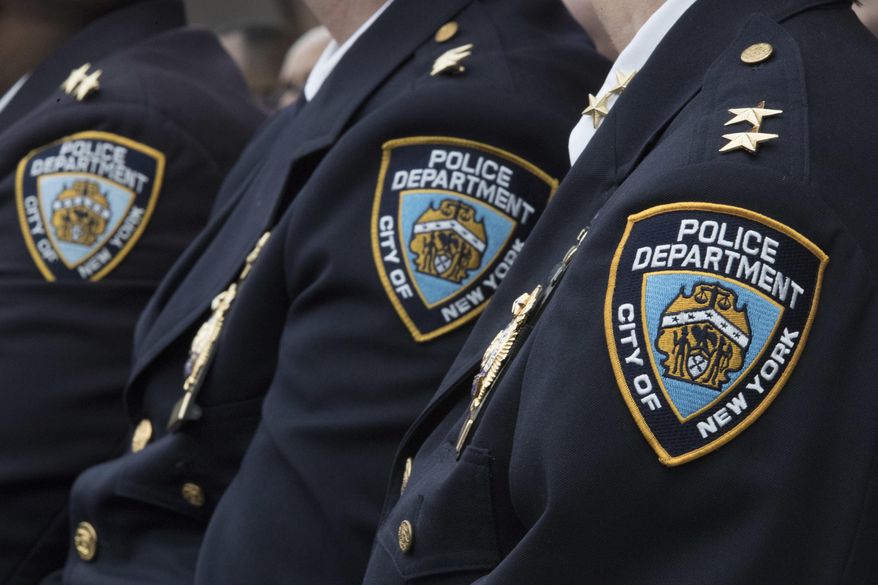 Members of the New York City Police Department listen to a news conference, Jan. 4, 2017, in New York. New York City's watchdog agency has launched an investigation into allegations that the city's police department improperly used its official social media accounts to target public officials and private citizens. The city Department of Investigation confirmed the probe in a statement Wednesday, May 8, 2024, saying it was prompted by recent requests from City Council Speaker Adrienne Adams and the Legal Aid Society asking it to look into the NYPD's social media policies and practices. (AP Photo/Mary Altaffer, File)
