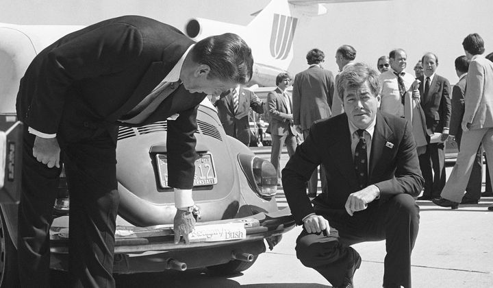 Republican presidential candidate Ronald Reagan, left, admires the bumper sticker on the car of Congressman Pete McCloskey as the congressman looks on, right, in San Jose, Calif., Sept. 25, 1980. Reagan was in the area on a campaign trip prior to leaving for more campaigning in Washington and Oregon. Former California Congressman McCloskey, who ran as a Republican challenging President Richard Nixon in 1972, has died at age 96. (AP Photo/Harrity, File)