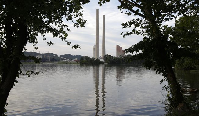 FILE - In this Aug. 7, 2019, photo, the Kingston Fossil Plant stands near a waterway in Kingston, Tenn. The nation’s largest public utility is moving ahead with a plan for a new natural gas plant in Tennessee despite warnings that its environmental review of the project doesn’t comply with federal law. The Environmental Protection Agency asked the Tennessee Valley Authority in a March 25, 2024 letter to redo several aspects of its environmental impact statement for converting the coal-burning Kingston Fossil Plant. (AP Photo/Mark Humphrey, File)