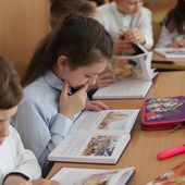 A child in Ukraine studies a Bible as part of the Eastern European Mission to bring Bibles into Ukrainian schools. Photo Courtesy of Eastern European Mission.