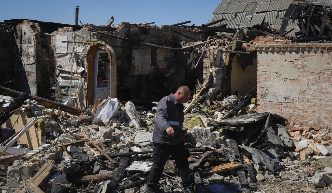 A gas worker inspects a ruined private house after a Russian missile attack in Kyiv region, Ukraine, Wednesday, May 8, 2024. (AP Photo/Efrem Lukatsky)