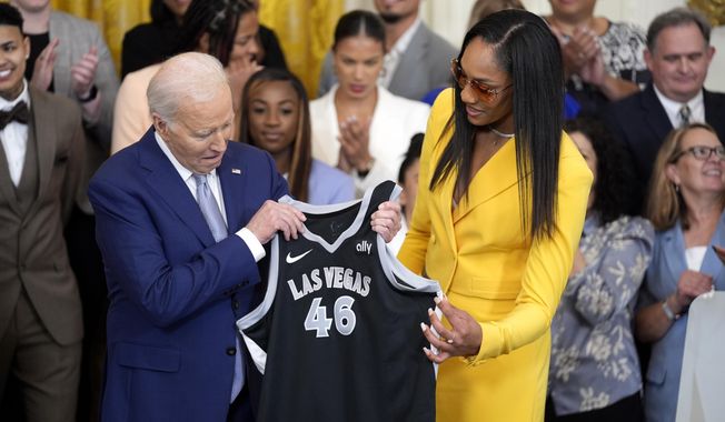 A&#x27;ja Wilson, of the WNBA&#x27;s Las Vegas Aces, right, presents a jersey to President Joe Biden during an event to celebrate the 2023 WNBA championship team, in the East Room of the White House, Thursday, May 9, 2024, in Washington. (AP Photo/Evan Vucci)