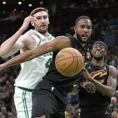 Cleveland Cavaliers forward Evan Mobley, center, and guard Caris LeVert, right, and Boston Celtics center Luke Kornet watch the ball get away during the first half of Game 2 of an NBA basketball second-round playoff series Thursday, May 9, 2024, in Boston. (AP Photo/Steven Senne)