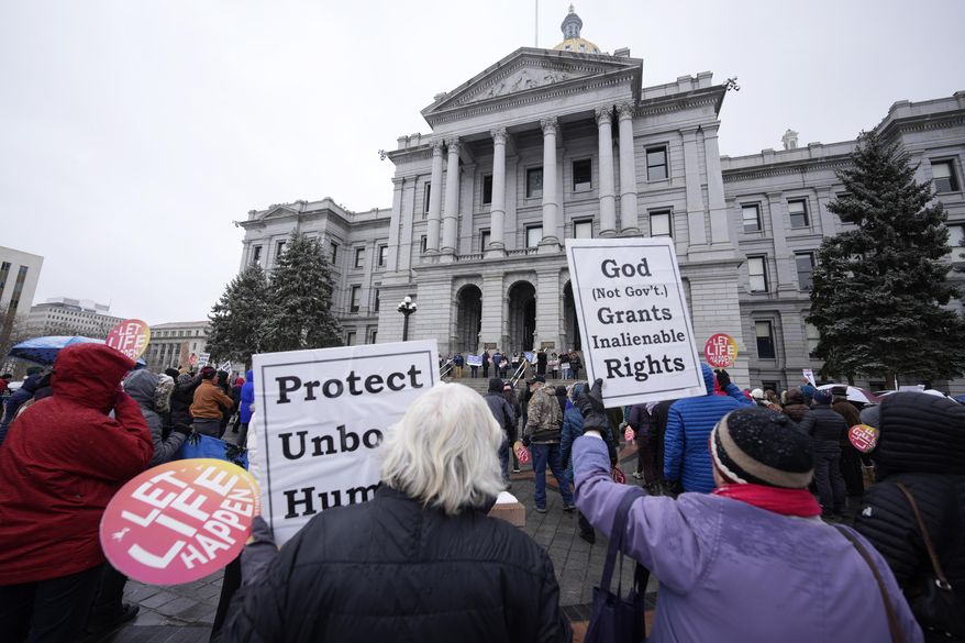 Attendees protest the one-year anniversary of Colorado's abortion law, the Reproductive Health Equity Act, Tuesday, April 4, 2023, outside the State Capitol in downtown Denver. A Colorado abortion fund said Thursday, May 9, 2024, it's helped hundreds access abortion in the first months of 2024, many arriving from Texas and other states where abortion is restricted, showing a continued increase in demand since the U.S. Supreme Court overturned Roe v. Wade in 2022. (AP Photo/David Zalubowski) **FILE**