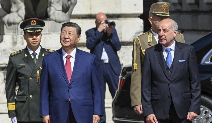 Hungarian President Tamas Sulyok, front right, receives Chinese President Xi Jinping, front left, with military honors in the Lion Court of the Castle of Buda in Budapest, Thursday, May 9, 2024. (Szilard Koszticsak/MTI via AP)