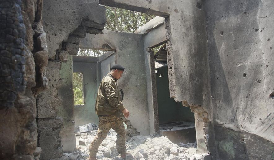 Saw Win Myint, a commander of a military unit under the Karen National Union, the leading political body for the Karen ethnic minority that is part of the resistance against military rule in Myanmar, inspects the damaged armory in the captured army base of Infantry Battalion 275 in Myawaddy township in Kayin state, Myanmar, on April 12, 2024. Six months into an offensive against Myanmar’s military administration, opposition forces have made massive gains, but civilian casualties are rising sharply as regime troops increasingly turn toward scorched-earth tactics in the Southeast Asian country's bitter civil war. (AP Photo/Metro, File)