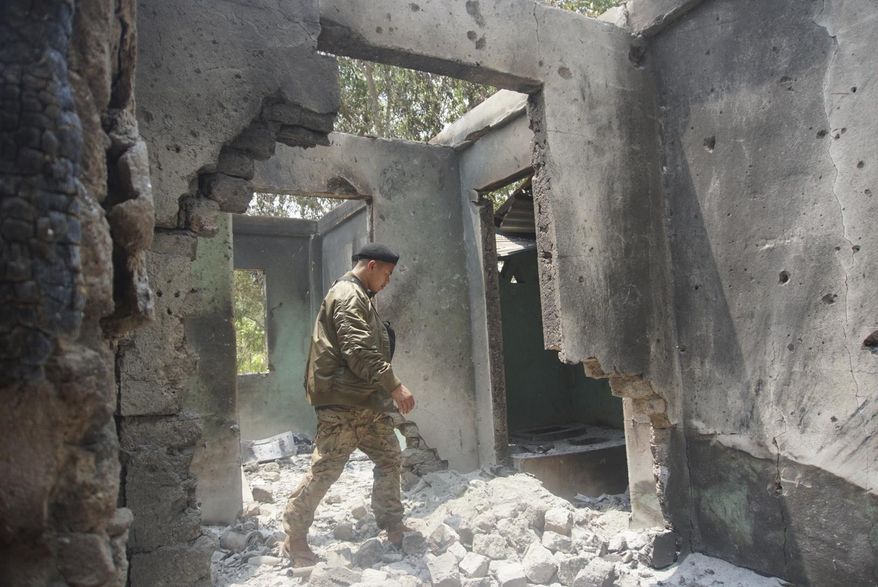 Saw Win Myint, a commander of a military unit under the Karen National Union, the leading political body for the Karen ethnic minority that is part of the resistance against military rule in Myanmar, inspects the damaged armory in the captured army base of Infantry Battalion 275 in Myawaddy township in Kayin state, Myanmar, on April 12, 2024. Six months into an offensive against Myanmar’s military administration, opposition forces have made massive gains, but civilian casualties are rising sharply as regime troops increasingly turn toward scorched-earth tactics in the Southeast Asian country's bitter civil war. (AP Photo/Metro, File)