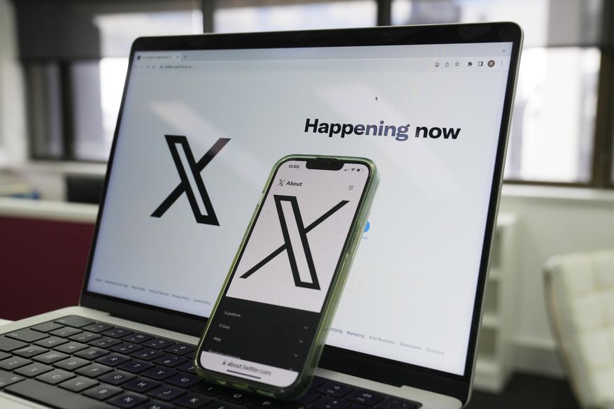 The opening page of X is displayed on a computer and phone in Sydney on Oct. 16, 2023. (AP Photo/Rick Rycroft, File)