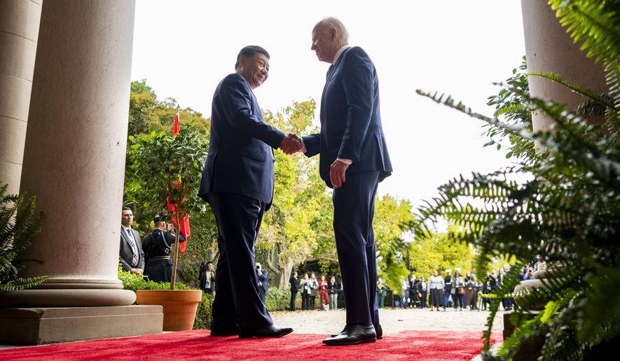 FILE -President Joe Biden, right, greets China's President President Xi Jinping, left, at the Filoli Estate in Woodside, USA, Wednesday, Nov. 15, 2023. High-level envoys from the United States and China are set to meet in Geneva for talks about artificial intelligence including the risks of the technology and ways to set shared standards to manage it. The meeting Tuesday is billed as an opening exchange of views in an inter-governmental dialogue on AI agreed during a meeting between U.S. President Joe Biden and Chinese President Xi Jinping in San Francisco. (Doug Mills/The New York Times via AP, Pool, File)