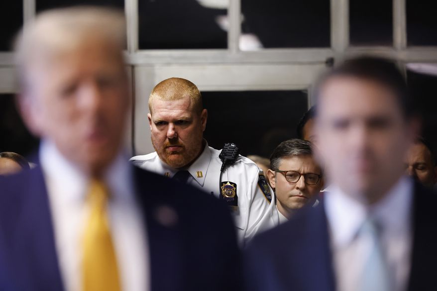 U.S. Speaker of the House Mike Johnson (R-LA) listens as former President Donald Trump speaks to the media as he arrives for his trial at Manhattan criminal court before his trial in New York, Tuesday, May 14, 2024. (Michael M. Santiago/Pool Photo via AP)
